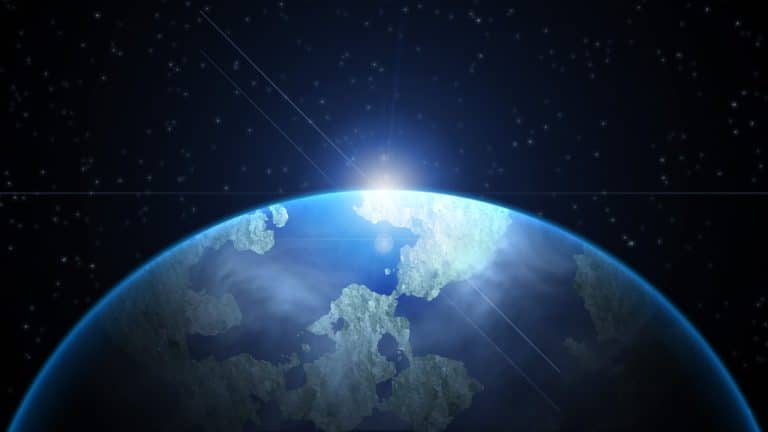 The sun rises behind the earth